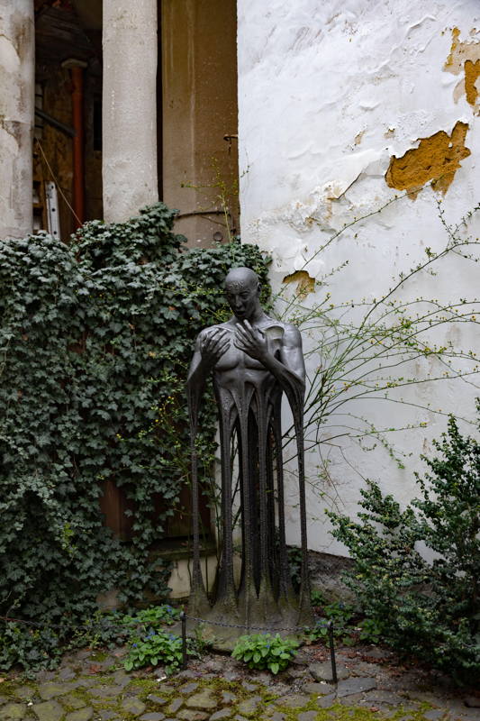 Modern statue of golem in small garden